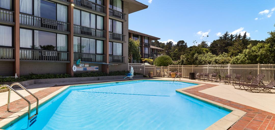 Outdoor hotel pool with lounge seating